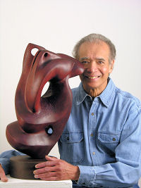 Ralph Baney poses with the sculpture